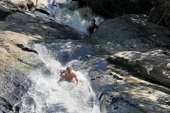 El Yunque Rainforest- Water Slide, Luquillo Beach Guided Tour - Stop 2: Las Pailas water slide experience in volcanic-rock pools